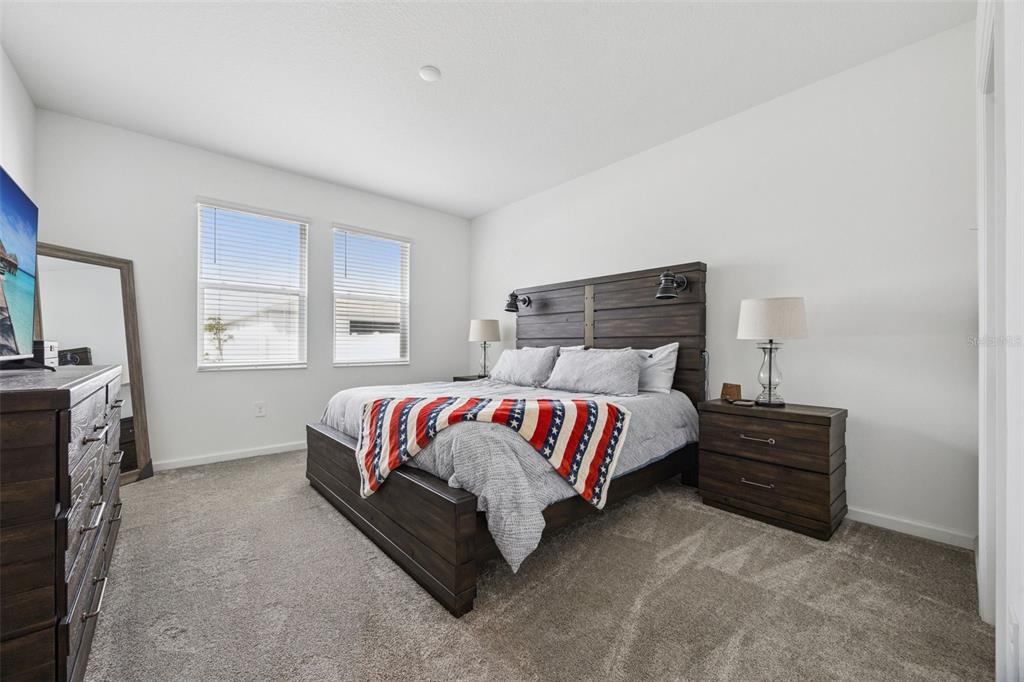 2714 Slash Way St. Cloud, FL 34771 - Photo 22 of 50 a bed sitting in a bedroom next to a window with tv