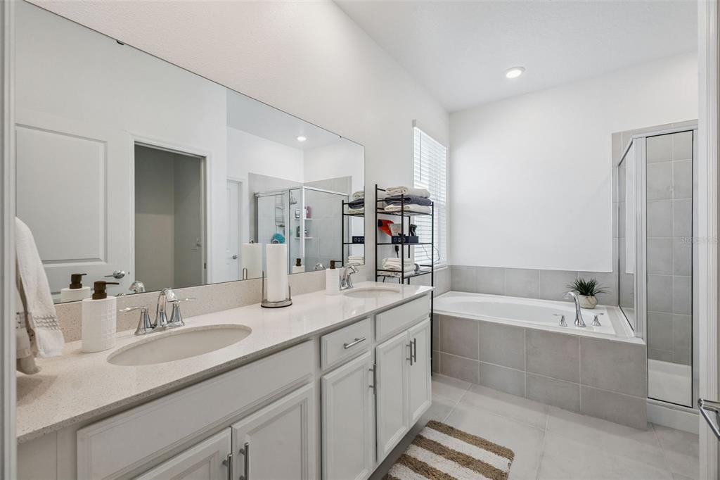 2714 Slash Way St. Cloud, FL 34771 - Photo 24 of 50 a bathroom with a tub double sink window and mirror