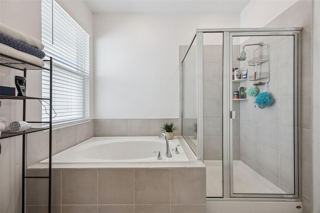 2714 Slash Way St. Cloud, FL 34771 - Photo 26 of 50 a white bath tub sitting next to a shower