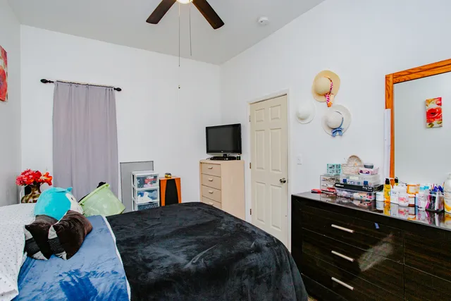 a bedroom with a bed and a television