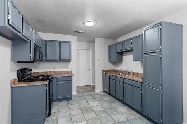 a kitchen with stainless steel appliances granite countertop a stove a refrigerator and a sink