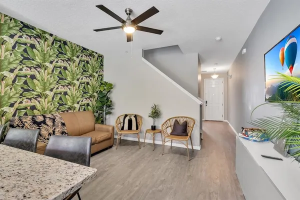a living room with furniture and a potted plant
