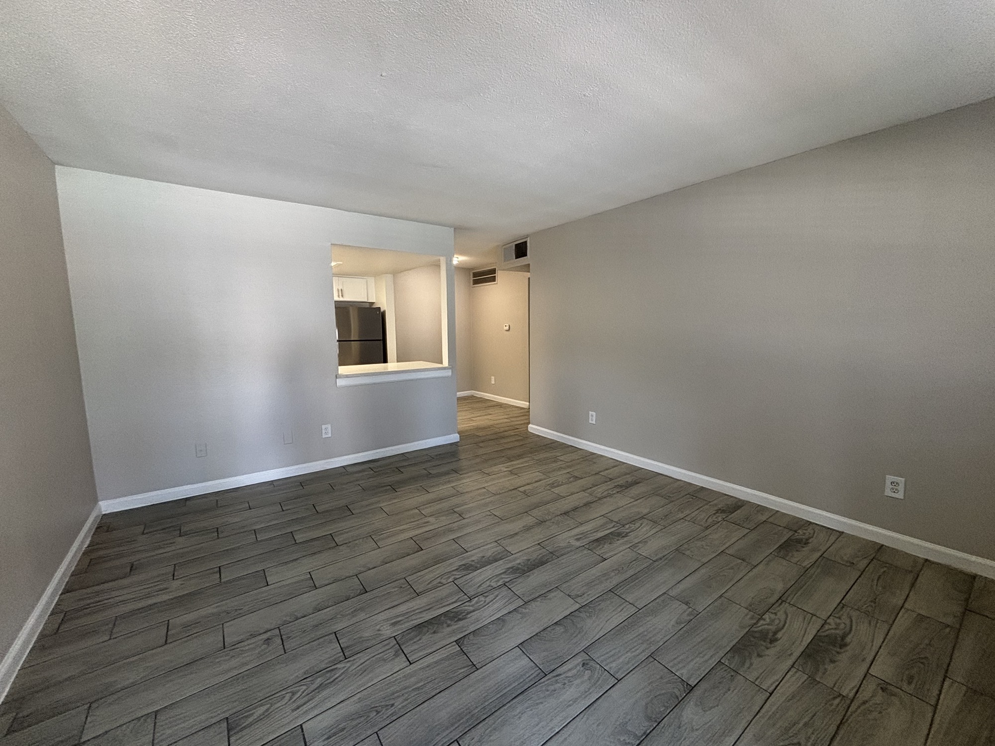600 Nottingham Oaks Trail, Unit 145 Houston, TX 77079 - Photo 3 of 10 a view of an empty room with wooden floor and a window