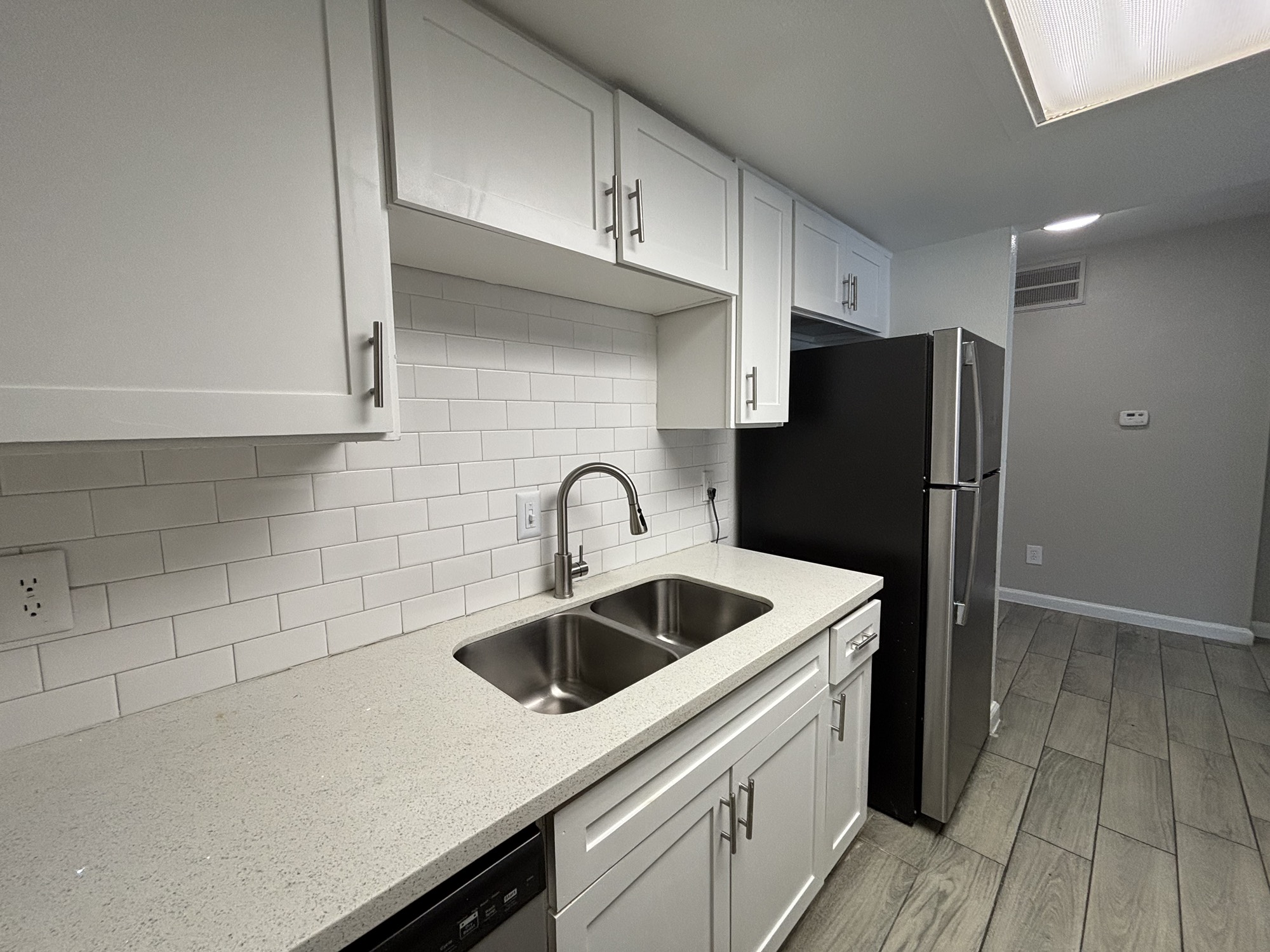 600 Nottingham Oaks Trail, Unit 145 Houston, TX 77079 - Photo 5 of 10 a kitchen with stainless steel appliances a refrigerator sink and cabinets