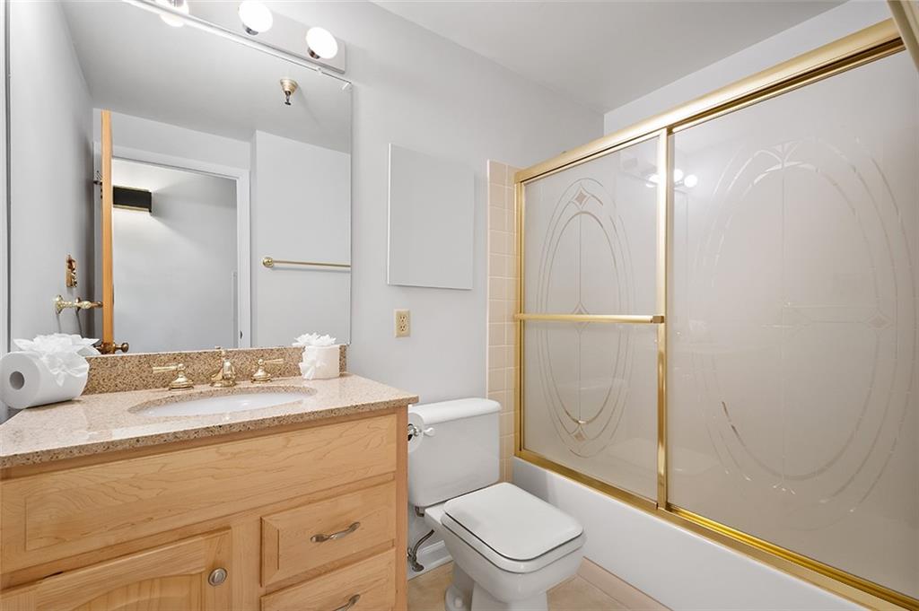 750 Washington Road, Unit 610 Pittsburgh, PA 15228 - Photo 21 of 25 a bathroom with a granite countertop sink toilet a mirror and shower