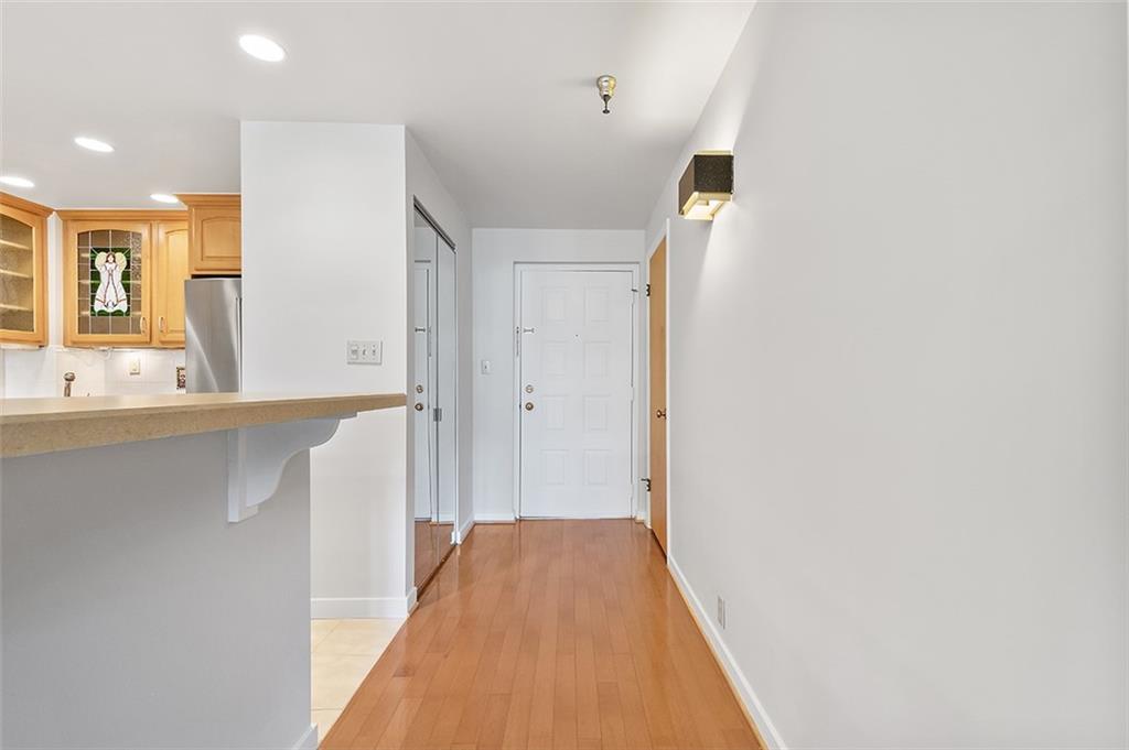 750 Washington Road, Unit 610 Pittsburgh, PA 15228 - Photo 6 of 25 a view of a hallway with wooden floor and a bathroom
