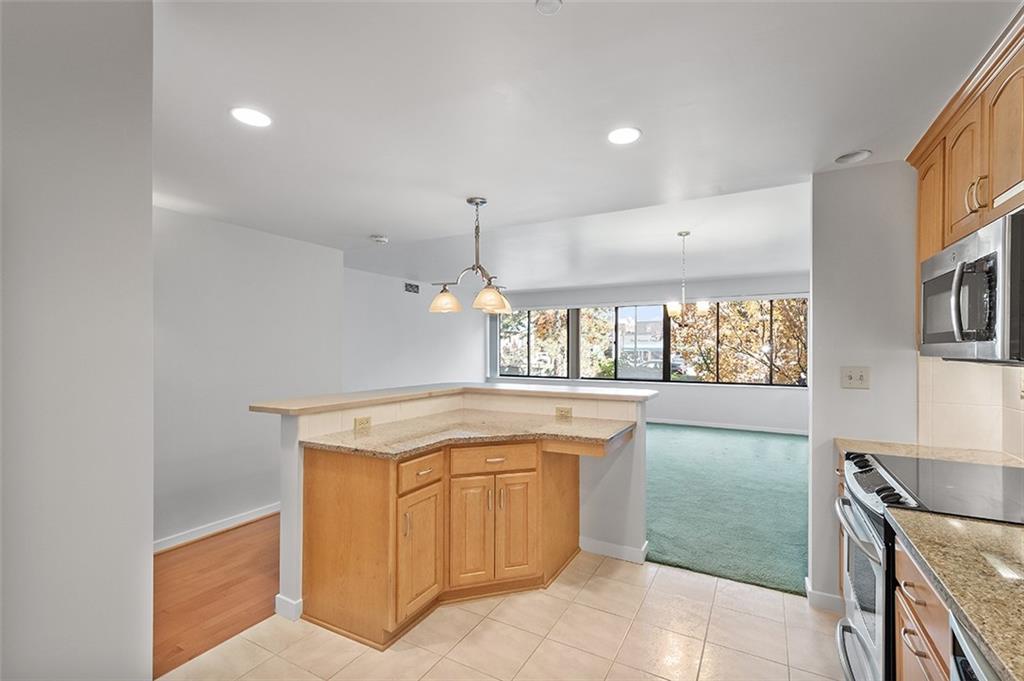 750 Washington Road, Unit 610 Pittsburgh, PA 15228 - Photo 10 of 25 a kitchen with a sink a stove a microwave and cabinets