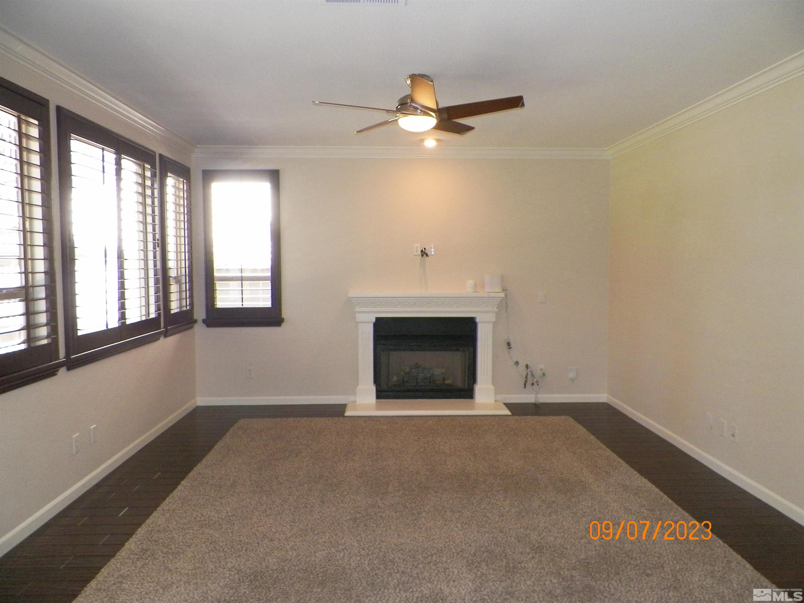 14031 Welsh Mountain Court Reno, NV 89521 - Photo 13 of 40 an empty room with windows and fireplace