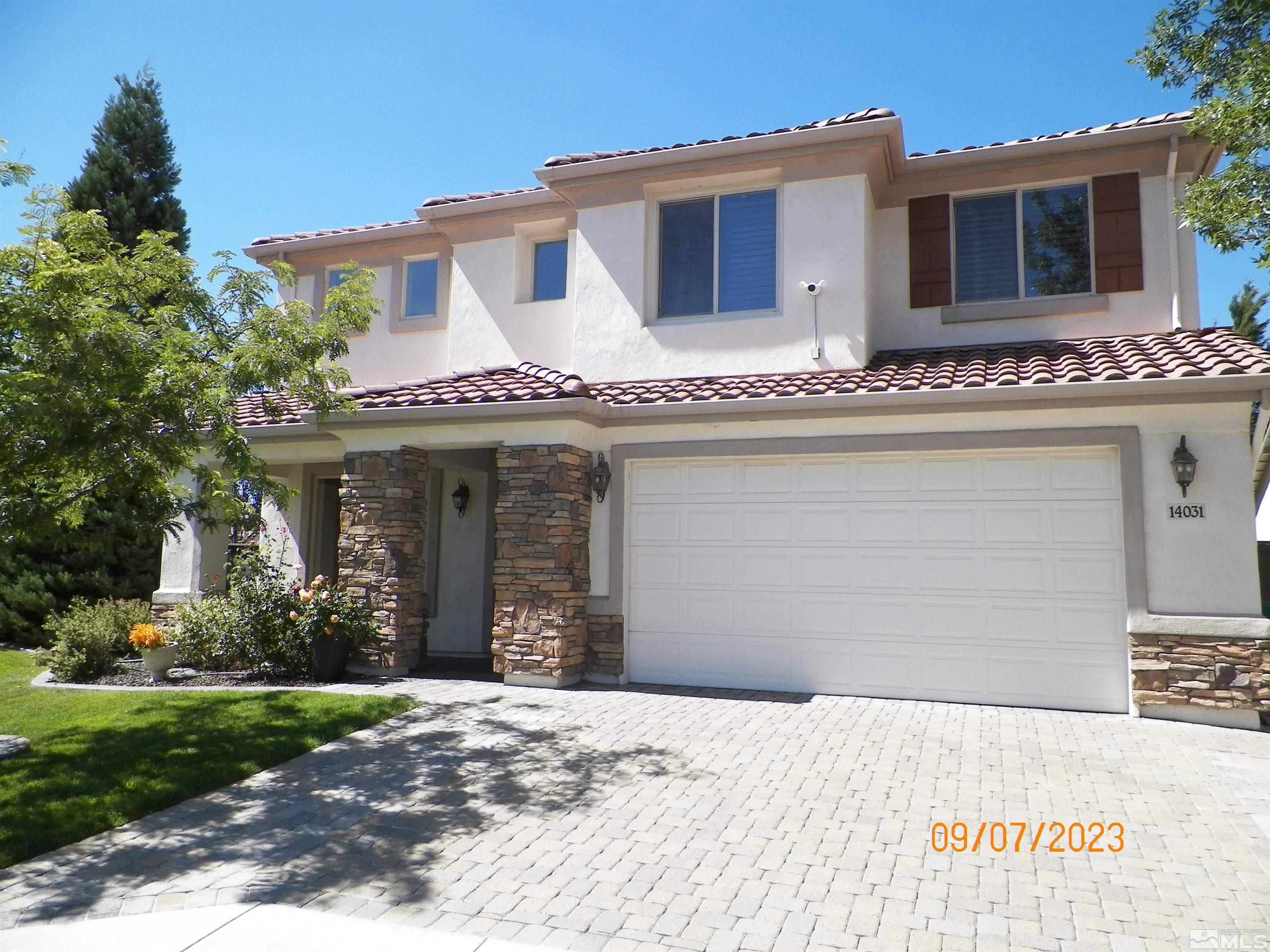 14031 Welsh Mountain Court Reno, NV 89521 - Photo 3 of 40 front view of a house with a yard