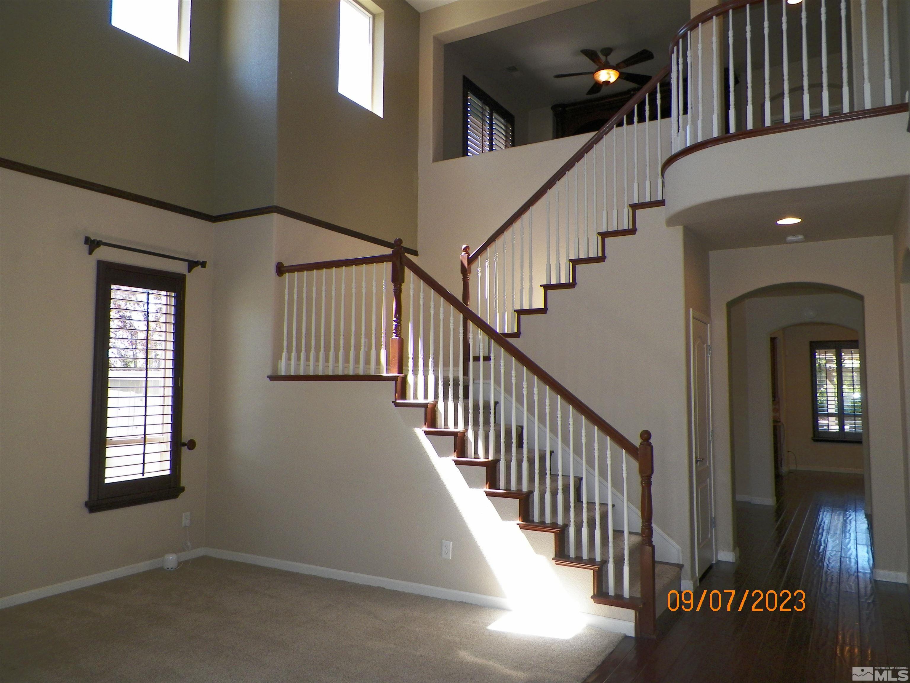 14031 Welsh Mountain Court Reno, NV 89521 - Photo 10 of 40 a view of staircase with lots of frames on wall and a window