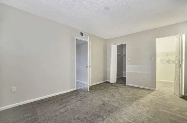 an empty room with closet area