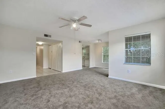 a view of an empty room with a window