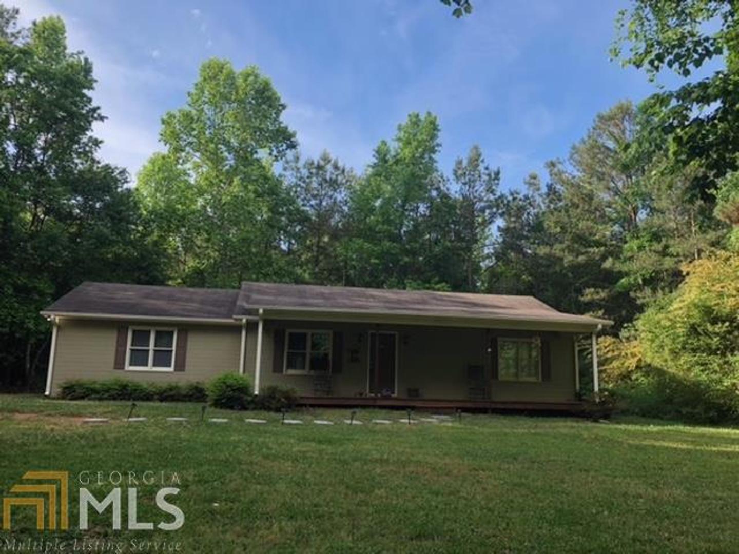1073 Gum Creek Airport Road Roopville, GA 30170 - Photo 1 of 1 a front view of a house with garden