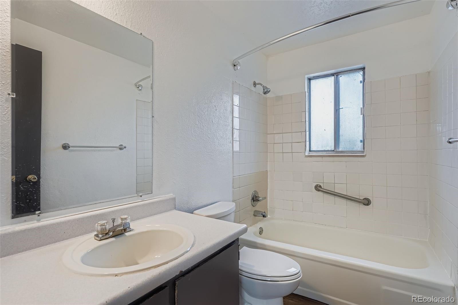 1080 South Eliot Street, Unit 203 Denver, CO 80219 - Photo 13 of 13 a bathroom with a sink toilet and shower
