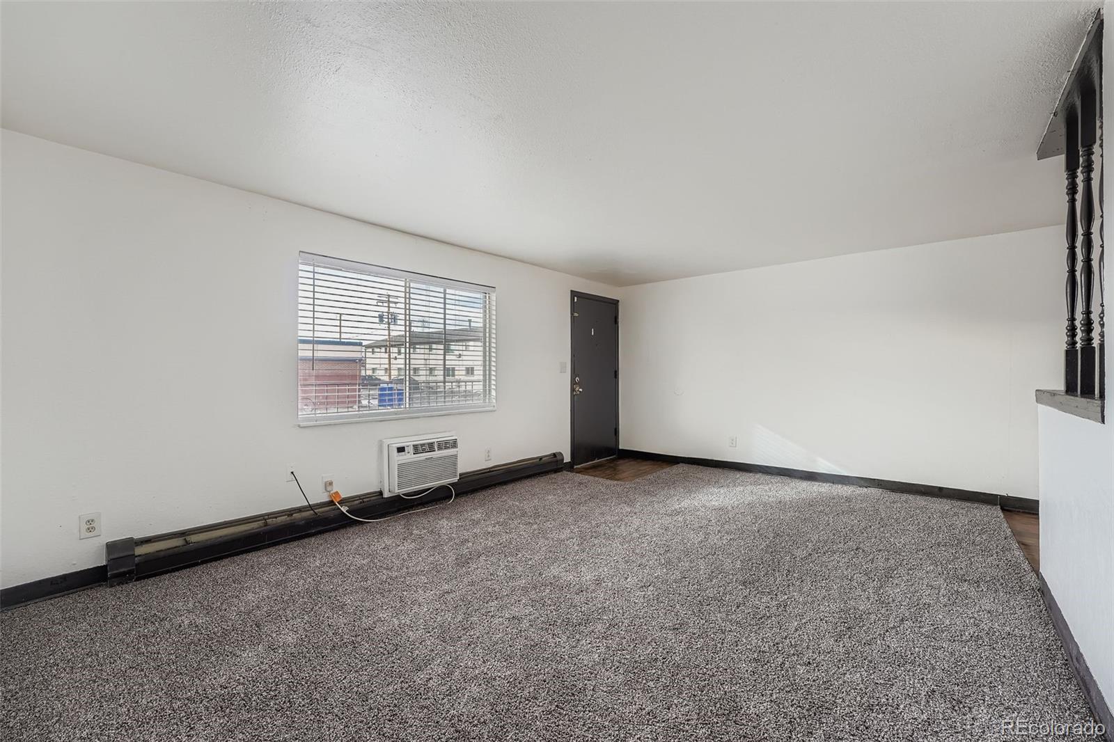 1080 South Eliot Street, Unit 203 Denver, CO 80219 - Photo 8 of 13 an empty room with windows