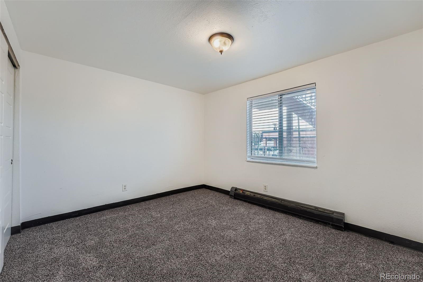 1080 South Eliot Street, Unit 203 Denver, CO 80219 - Photo 9 of 13 an empty room with a empty space and windows