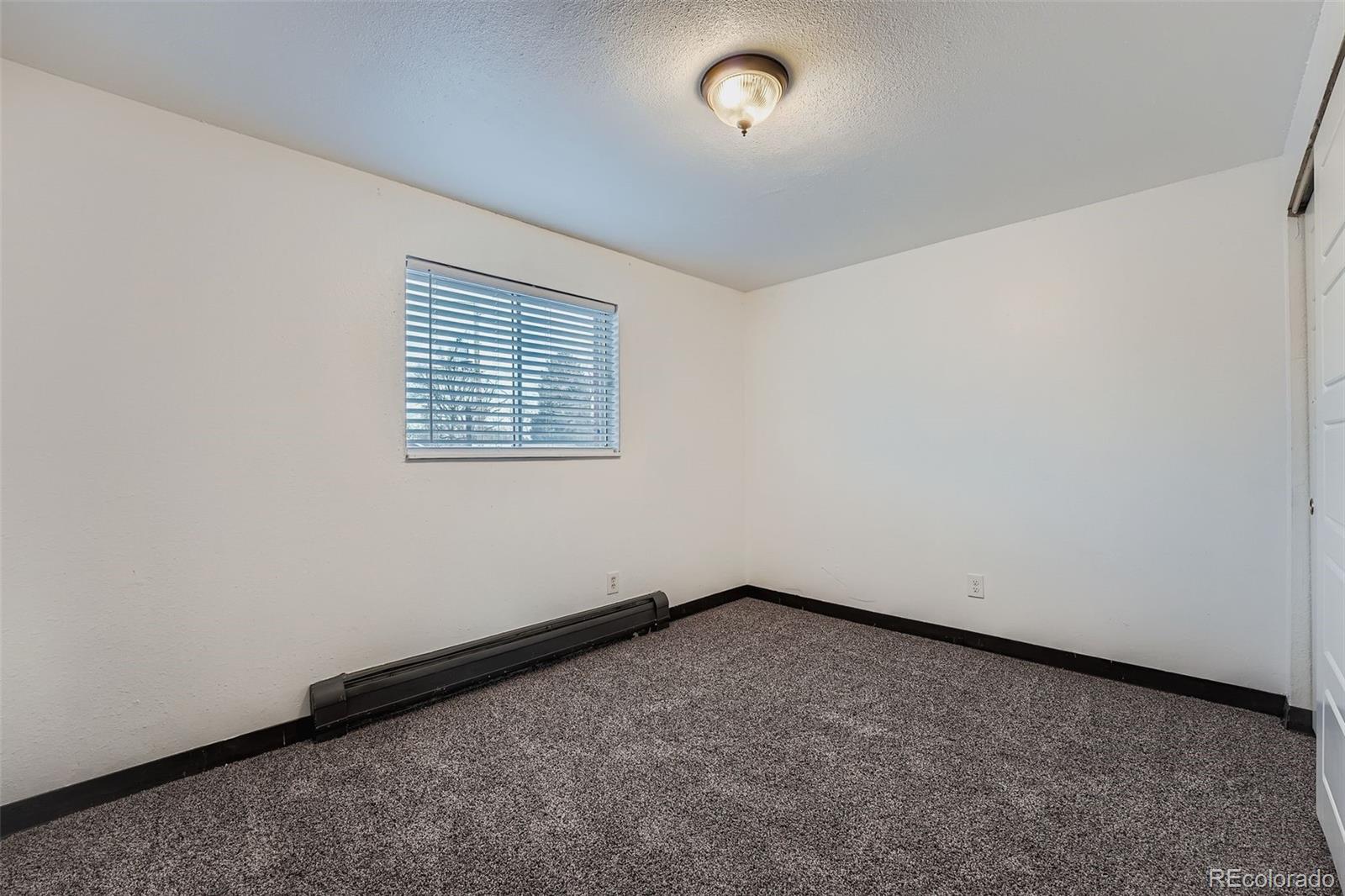 1080 South Eliot Street, Unit 203 Denver, CO 80219 - Photo 10 of 13 an empty room with a window