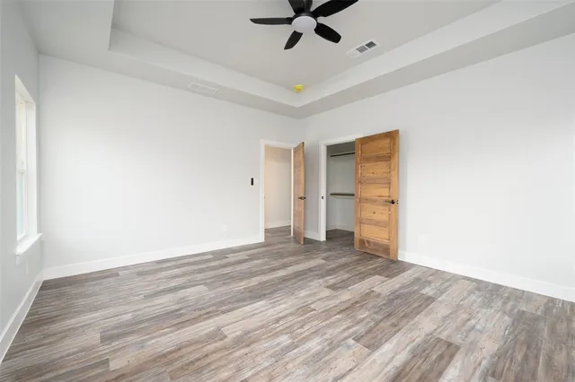 a bathroom with a granite countertop toilet sink and mirror