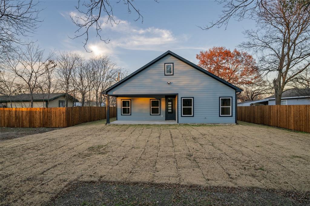 411 West Elm Street Whitewright, TX 75491 - Photo 16 of 26 a front view of house with yard and trees
