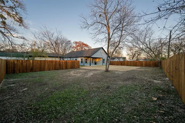 a front view of house with yard and trees