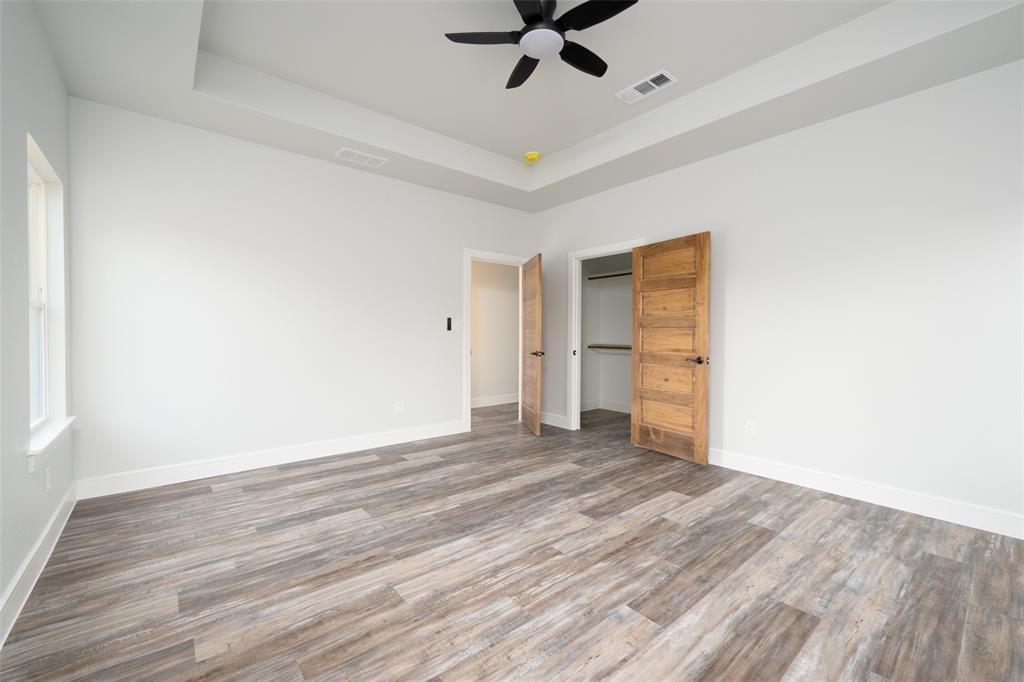 411 West Elm Street Whitewright, TX 75491 - Photo 18 of 31 a view of a room with wooden floor and ceiling fan