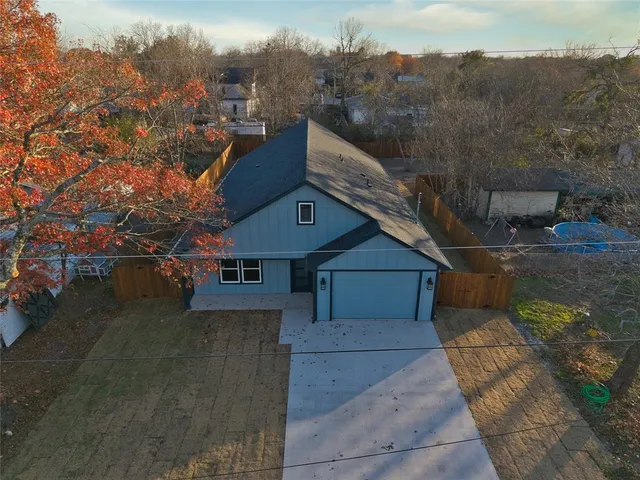 a front view of house with yard and trees around