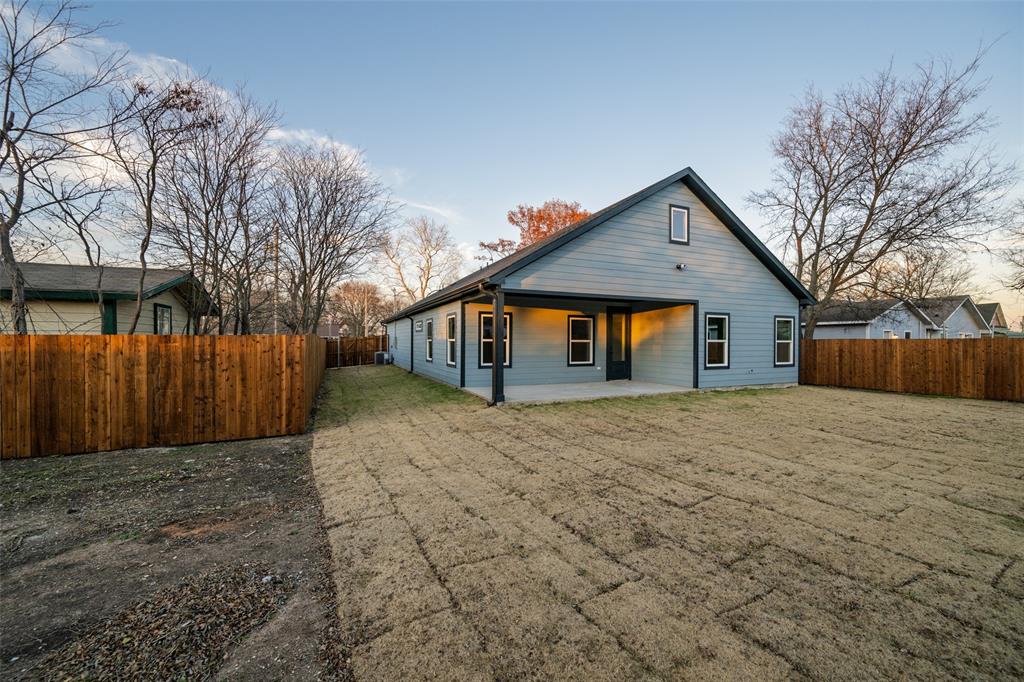 411 West Elm Street Whitewright, TX 75491 - Photo 22 of 31 a front view of house with a yard and trees