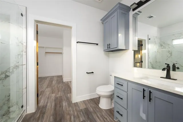 a view of an empty room with wooden floor