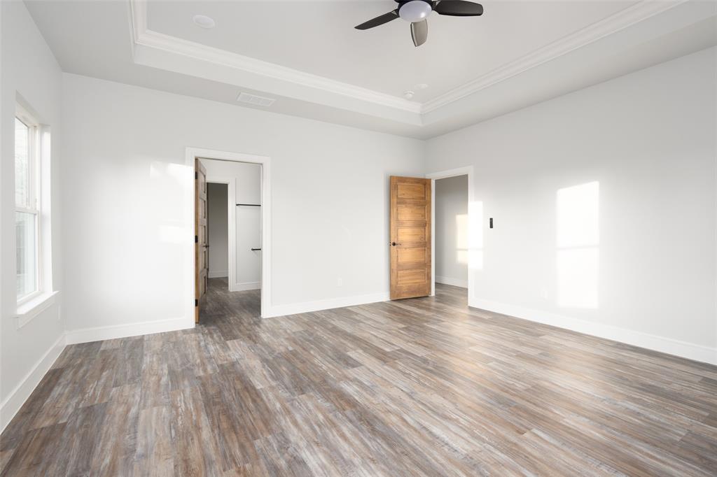 411 West Elm Street Whitewright, TX 75491 - Photo 7 of 31 a view of an empty room with wooden floor