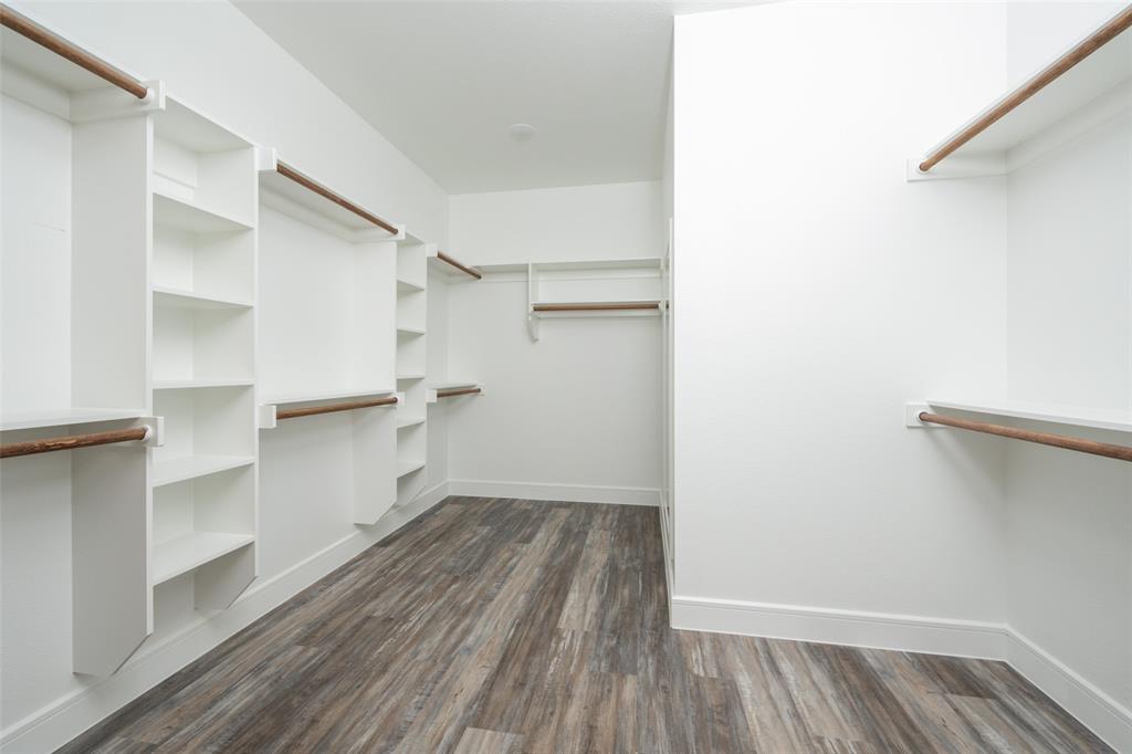 411 West Elm Street Whitewright, TX 75491 - Photo 8 of 26 a view of walk in closet with empty racks