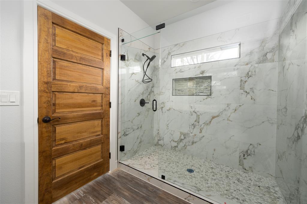 411 West Elm Street Whitewright, TX 75491 - Photo 9 of 31 a bathroom with a glass door shower