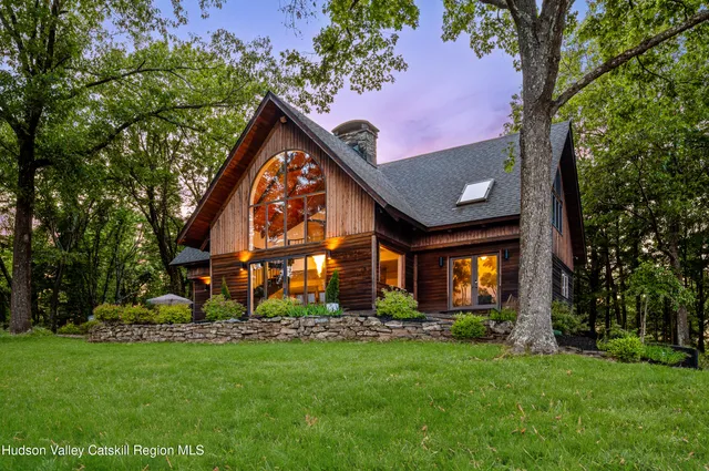 a front view of house with a garden