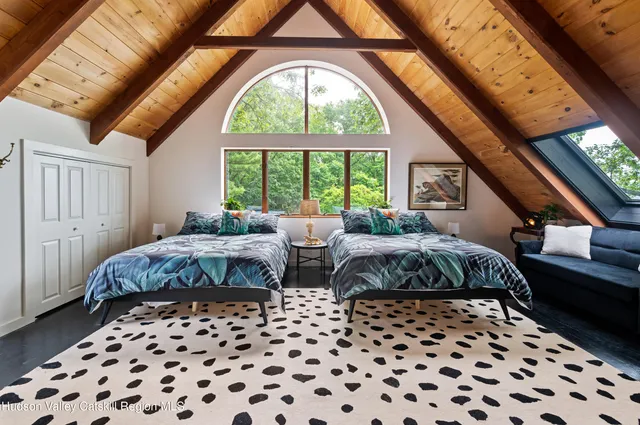 a bedroom with double bed and a window