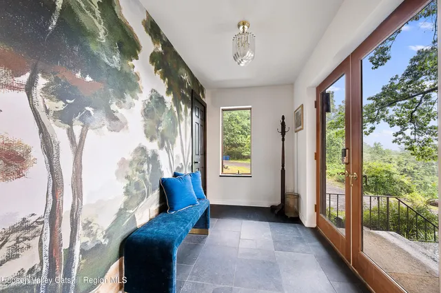 a living room with furniture and a floor to ceiling window