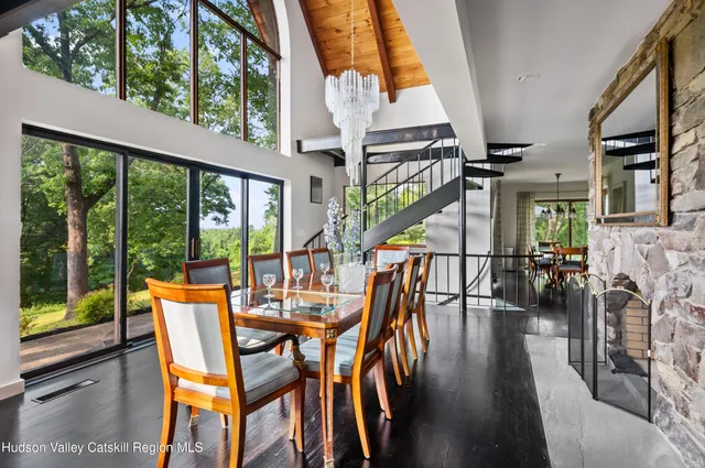 a dining room with furniture entryway and wooden floor