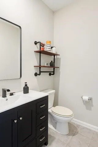 a bathroom with a toilet a sink and mirror