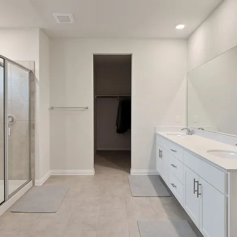 a bathroom with a double vanity sink and mirror