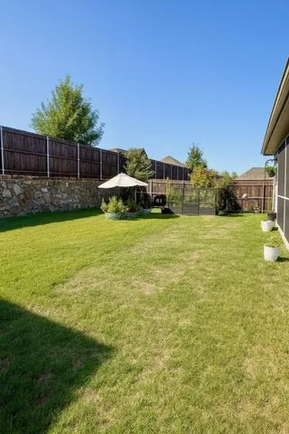 a view of a swimming pool with a yard and plants