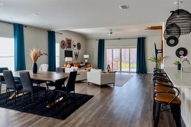 a living room with furniture and wooden floor