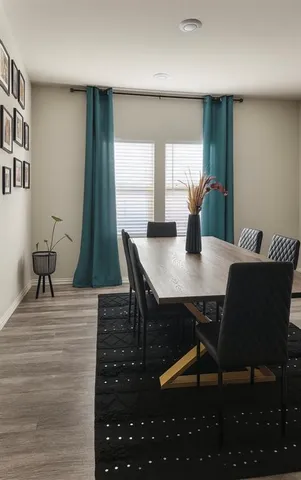 a view of a dining room with furniture and wooden floor