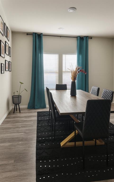 495 Sweet Lane Princeton, TX 75407 - Photo 9 of 20 a view of a dining room with furniture and wooden floor