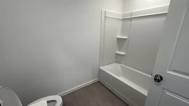 a bathroom with a bathtub and toilet