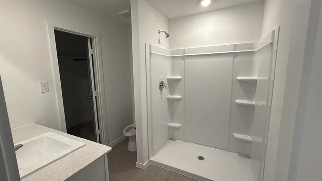 a bathroom with a shower and a sink