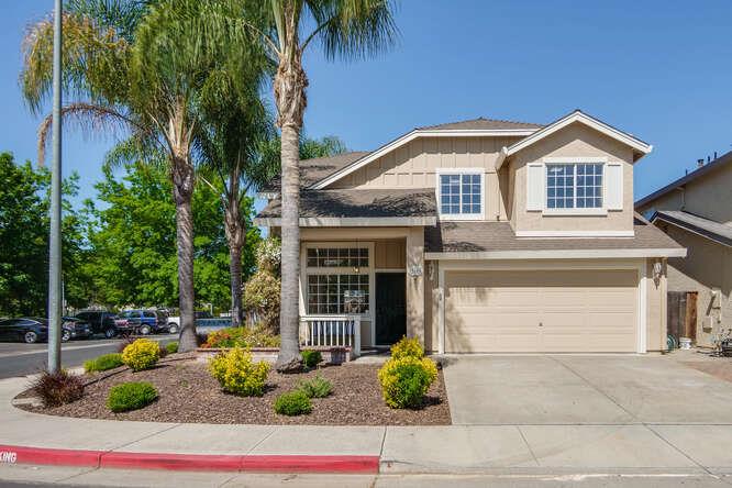 front view of house with potted plants