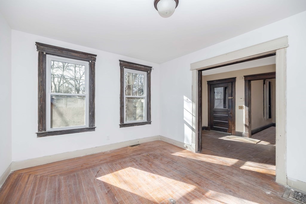 7-9 Cornell Street Springfield, MA 01109 - Photo 17 of 40 a view of an empty room with wooden floor and a window