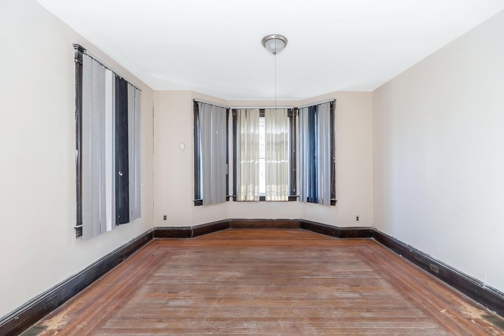 7-9 Cornell Street Springfield, MA 01109 - Photo 20 of 40 a view of an empty room with wooden floor and a window