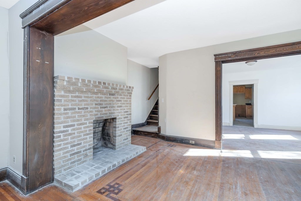 7-9 Cornell Street Springfield, MA 01109 - Photo 21 of 40 a view of empty room with wooden floor and fireplace