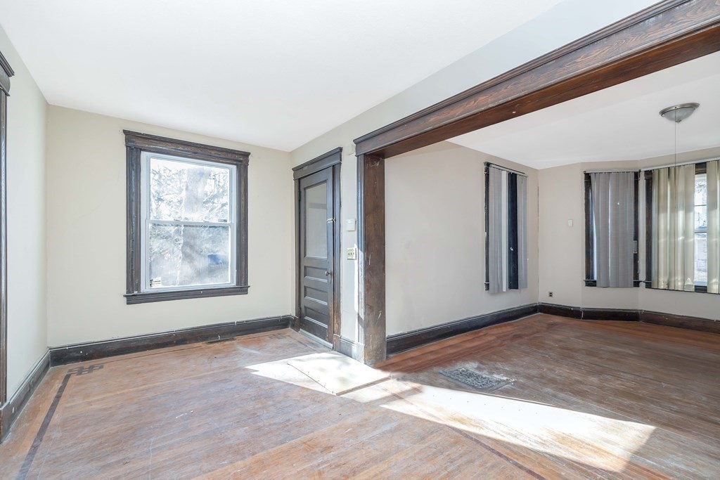 7-9 Cornell Street Springfield, MA 01109 - Photo 23 of 40 a view of an empty room with window and wooden floor