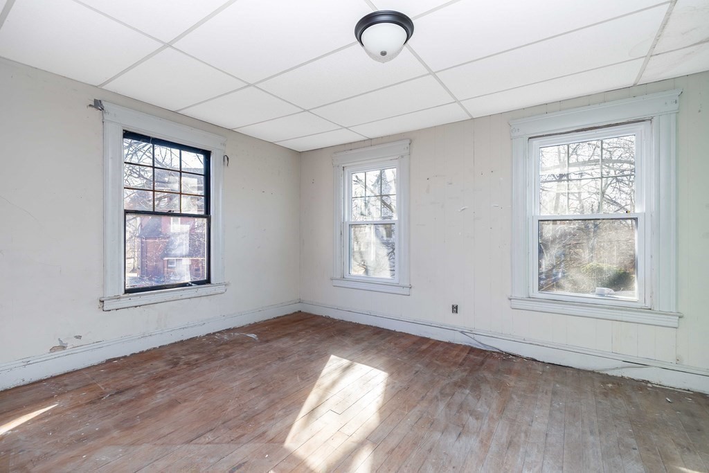 7-9 Cornell Street Springfield, MA 01109 - Photo 25 of 40 an empty room with wooden floor and windows