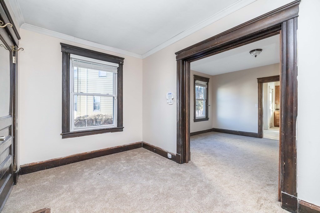 7-9 Cornell Street Springfield, MA 01109 - Photo 5 of 40 a view of an empty room with closet and a mirror